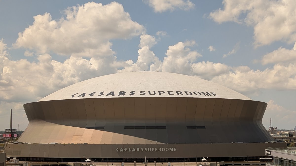 The Caesars Superdome home of the New Orleans Saints in downtown New Orleans under a partly cloudy sky