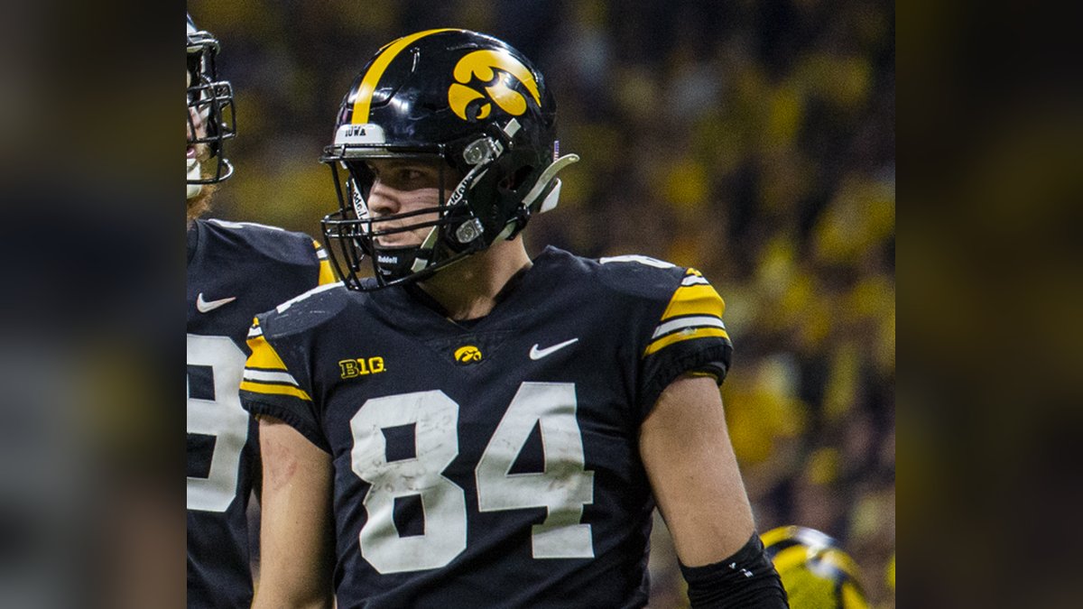 Sam LaPorta in a black No. 84 jersey and black helmet looking to the side on the field during a college game