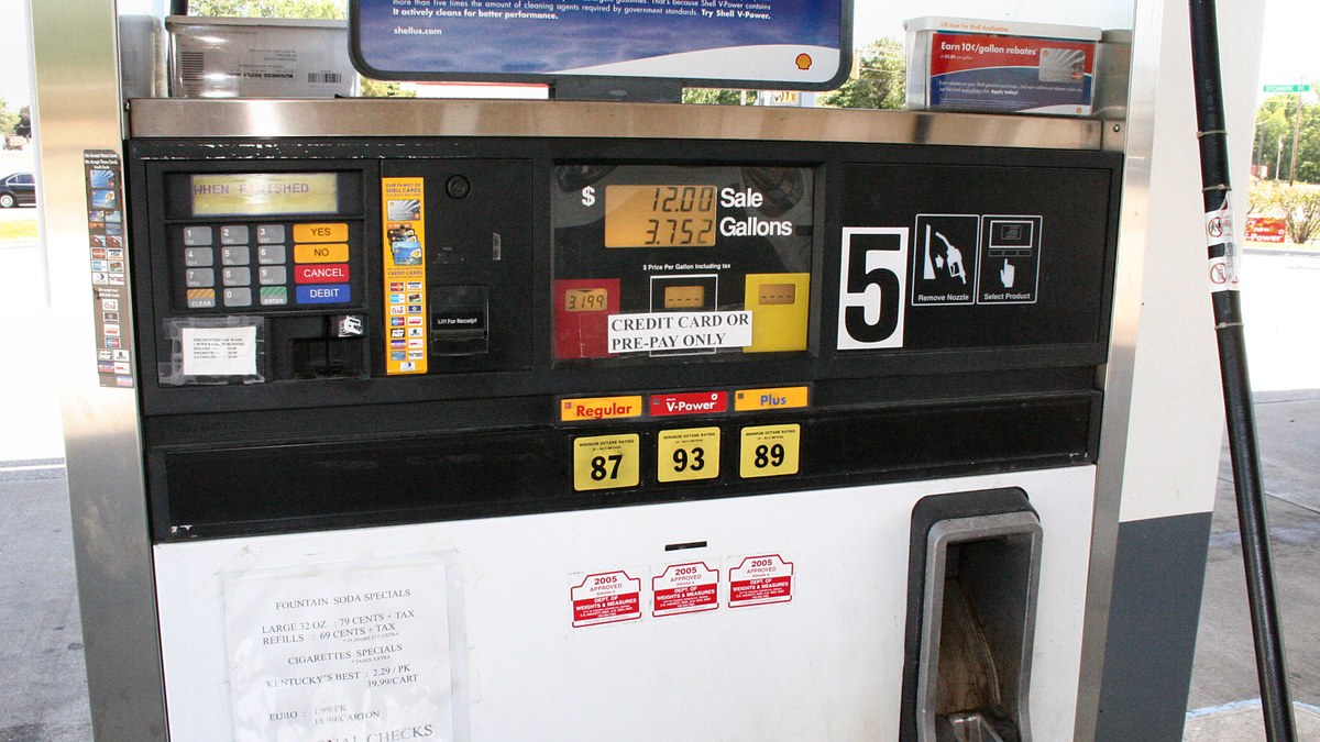 A pay-at-the-pump gasoline dispenser with digital price displays and fuel grade buttons at a U.S. filling station