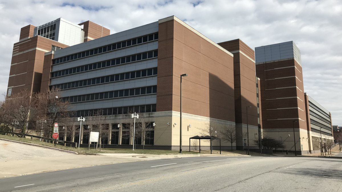 The brick and glass Social Security Administration Metro West office complex beside an empty street in downtown Baltimore