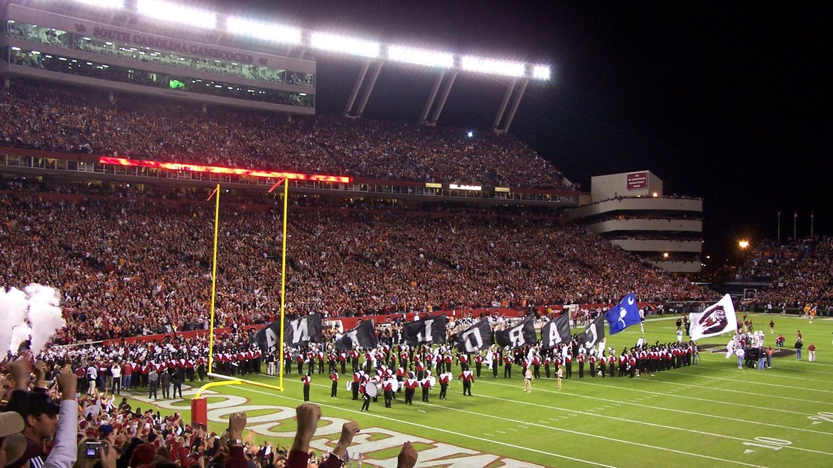 South Carolina Gamecocks fans cheering as the team takes the field under the lights at Williams-Brice Stadium