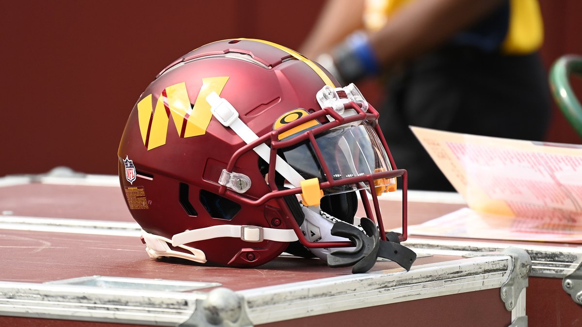A football helmet resting on an equipment case on an NFL sideline