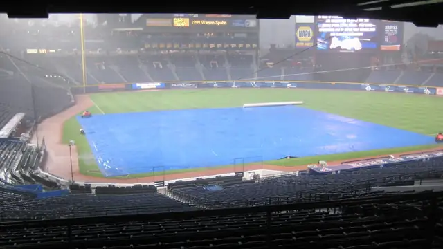 A blue tarp covers the infield at Turner Field in Atlanta during a 2008 rain delay as rows of empty seats sit in the foreground