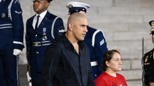 Alex Pereira in a black shirt walks down the steps of the Lincoln Memorial past a military honor guard at a UFC press event in June 2026