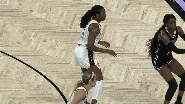 Indiana Fever forward Aliyah Boston in a white Fever uniform moves across the court in a game at Chase Center