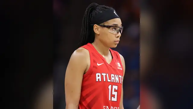 Atlanta Dream guard Allisha Gray in her red No. 15 jersey with a black headband and clear protective glasses during a 2024 game