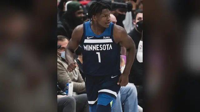 Anthony Edwards in a navy Minnesota Timberwolves No. 1 jersey jogging up the court during a 2021 game