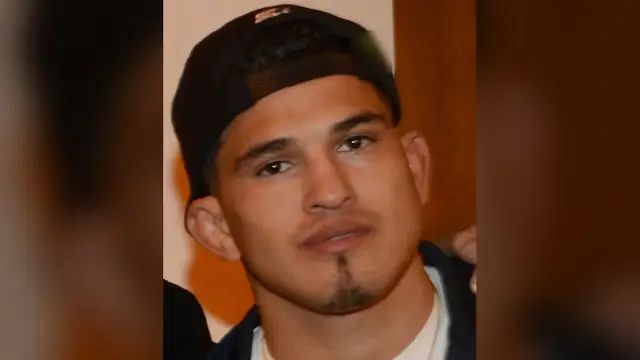 Anthony Pettis in a black backward cap and dark zip hoodie over a white T-shirt