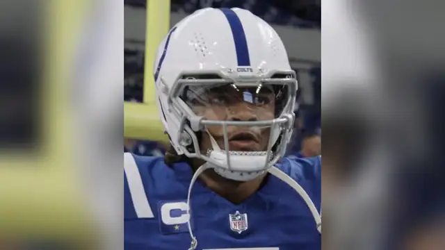 Colts quarterback Anthony Richardson in a white Colts helmet and blue jersey on the field