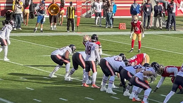 Bears quarterback Caleb Williams, No. 18, lines up behind his offensive line as Chicago faces the San Francisco 49ers at Levi's Stadium