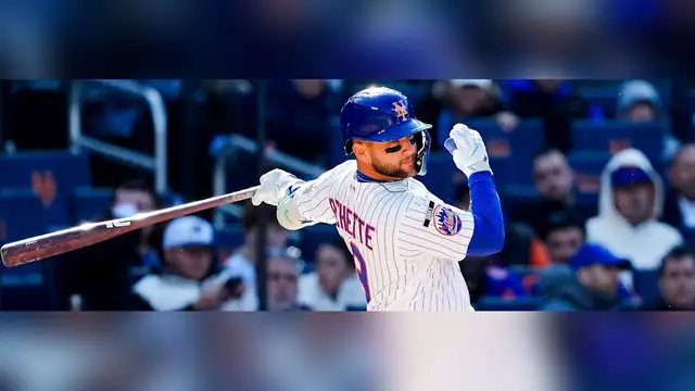 Bo Bichette swinging a bat in a white pinstriped New York Mets uniform