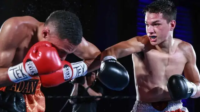 Brandon Figueroa throws a right hand at an opponent whose head is lowered during a fight