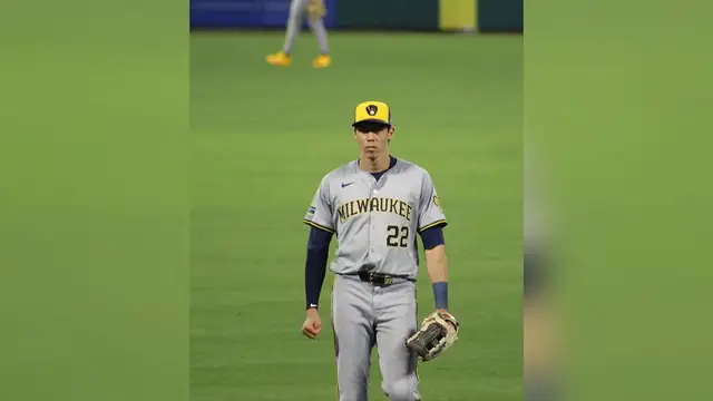 Christian Yelich standing in the outfield in a Milwaukee Brewers road uniform