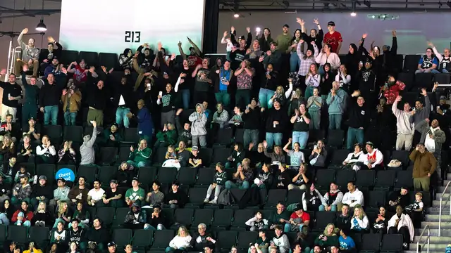 Fans stand and cheer in the upper seats during a Milwaukee Bucks home game at Fiserv Forum