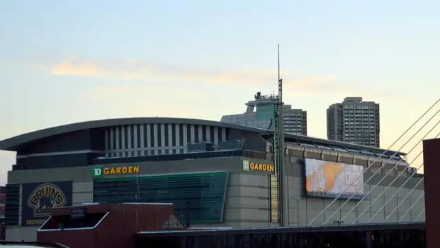 TD Garden arena glows in the evening light beside the Charlestown bridge in Boston