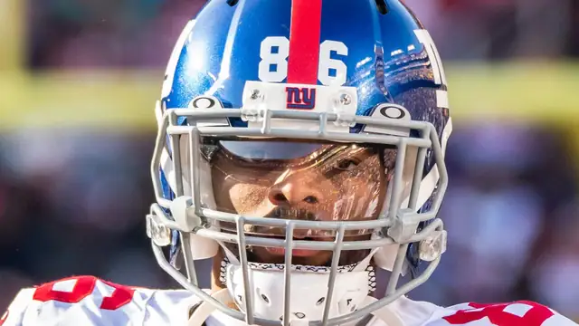 Darius Slayton in a blue Giants helmet with the No. 86 on a football field