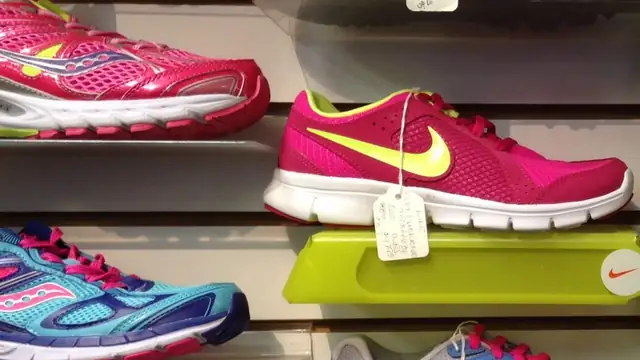 Rows of colorful sneakers displayed on a store wall