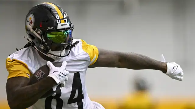 Cordarrelle Patterson in a white No. 84 Steelers practice jersey running with the football
