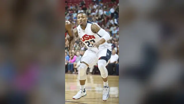 Damian Lillard in a white USA Basketball No. 22 jersey defending during a 2014 scrimmage in Las Vegas