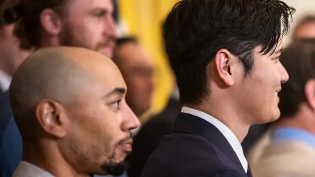 Mookie Betts and Shohei Ohtani in suits stand side by side at the White House in April 2025