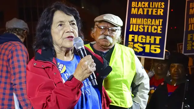 Dolores Huerta speaks into a microphone at a rally in Milwaukee in 2015