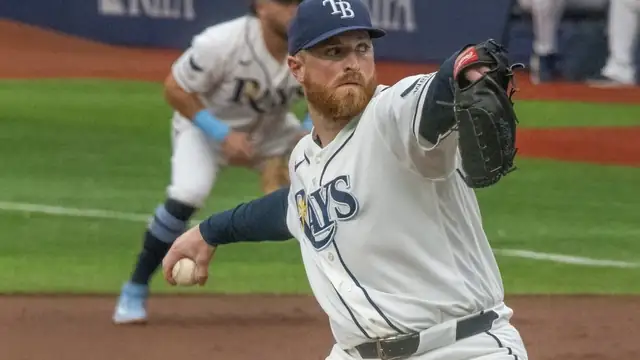 Tampa Bay Rays pitcher Drew Rasmussen delivers a pitch in a white home uniform during a game in June 2026