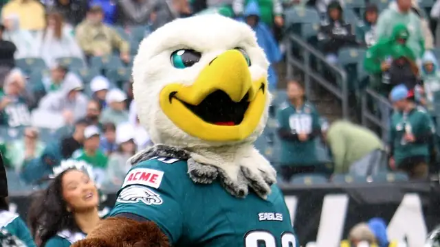 The Philadelphia Eagles mascot in a green team jersey cheers on the field in front of fans at Lincoln Financial Field