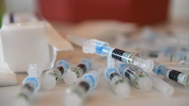 Prefilled flu vaccine syringes lined up on a clinic table