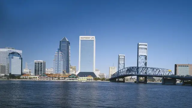 Downtown Jacksonville Florida skyline and Main Street Bridge across the St. Johns River under a clear blue sky