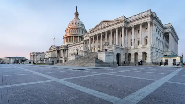 The U.S. Capitol dome and the House wing with its columns and wide stone steps above an empty plaza at sunrise