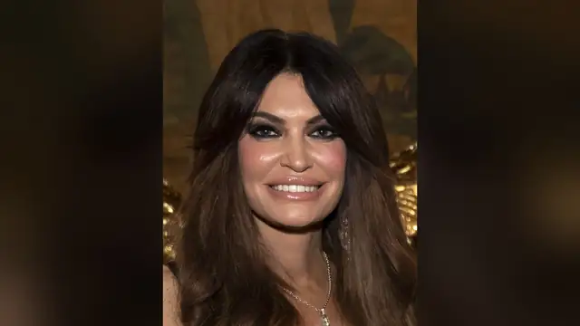 Kimberly Guilfoyle smiling at an evening event