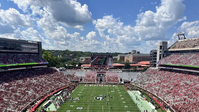 Packed red stands surround the green field and large G logo at Sanford Stadium in Athens
