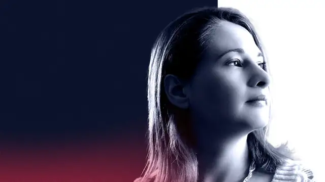 Gypsy Rose Blanchard in a soft profile portrait gazing to the right against a dark blue backdrop