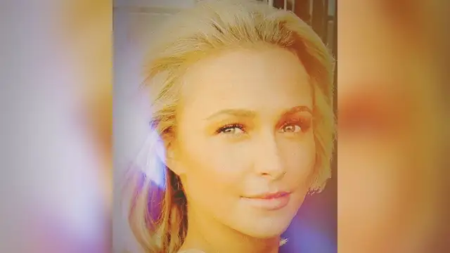 Hayden Panettiere smiling in a close-up portrait with her blond hair swept back