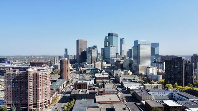 Downtown Minneapolis skyline with office towers and apartment buildings under a clear sky