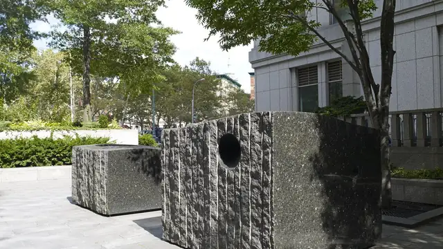 Granite sculpture blocks on the tree-lined plaza outside the Daniel Patrick Moynihan federal courthouse in Manhattan