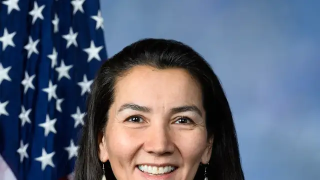 Mary Peltola smiling in her official congressional portrait in front of an American flag