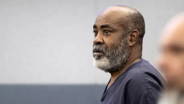Duane Davis in a navy jail uniform looking left in a Las Vegas courtroom