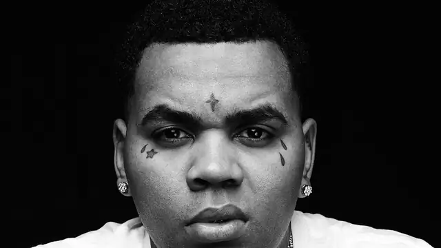 Kevin Gates in a black and white portrait wearing a white T-shirt