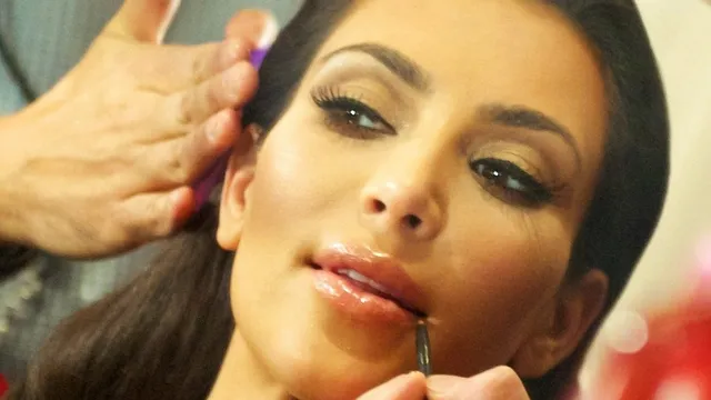 Kim Kardashian having her makeup applied backstage at a fashion show