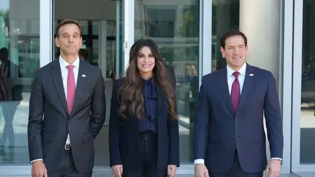 Kimberly Guilfoyle standing between Marco Rubio and an embassy official outside the U.S. Embassy in Athens