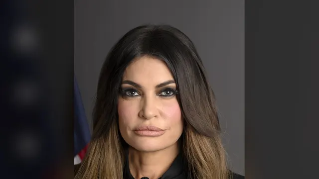 Kimberly Guilfoyle in her official State Department portrait with a dark backdrop
