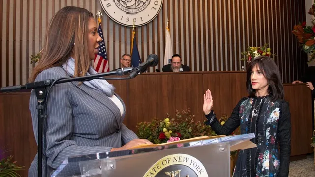 New York Attorney General Letitia James at a lectern with the state seal as a judge raises her right hand to take the oath