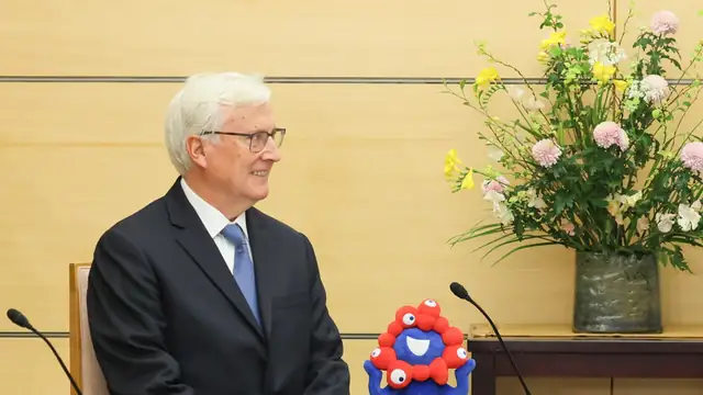 Dodgers owner Mark Walter seated at a meeting in Tokyo
