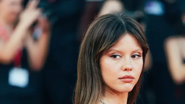 Mia Goth with dark bangs at a red carpet event