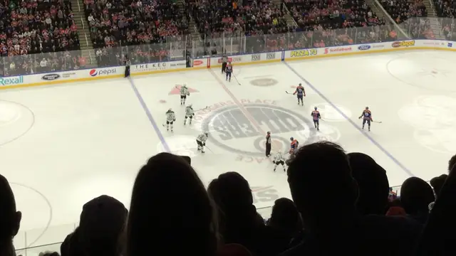 Fans in silhouette watching an Edmonton Oilers home game from the upper deck at Rogers Place