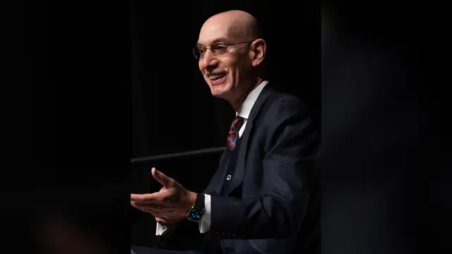NBA commissioner Adam Silver smiles while speaking on stage during 2024 NBA All-Star events in Indianapolis