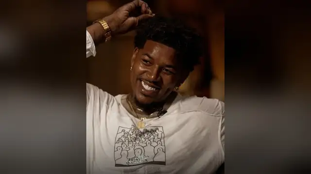 Nick Young smiling in a white T-shirt