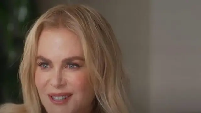 Nicole Kidman smiling with long blond hair during a sit-down interview