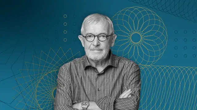 Physicist Francis Halzen in glasses with arms crossed against a blue graphic background